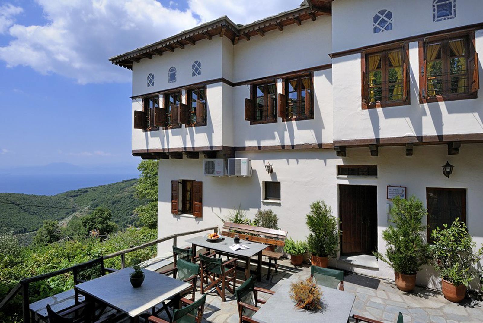 Hotel terrace with outdoor dining overlooking the sea